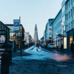 A bustling street view of Reykjavik featuring the iconic Hallgrimskirkja church in winter.