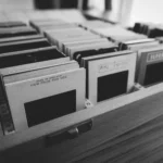 Black and white photo of vintage photography slides organized in a wooden box.
