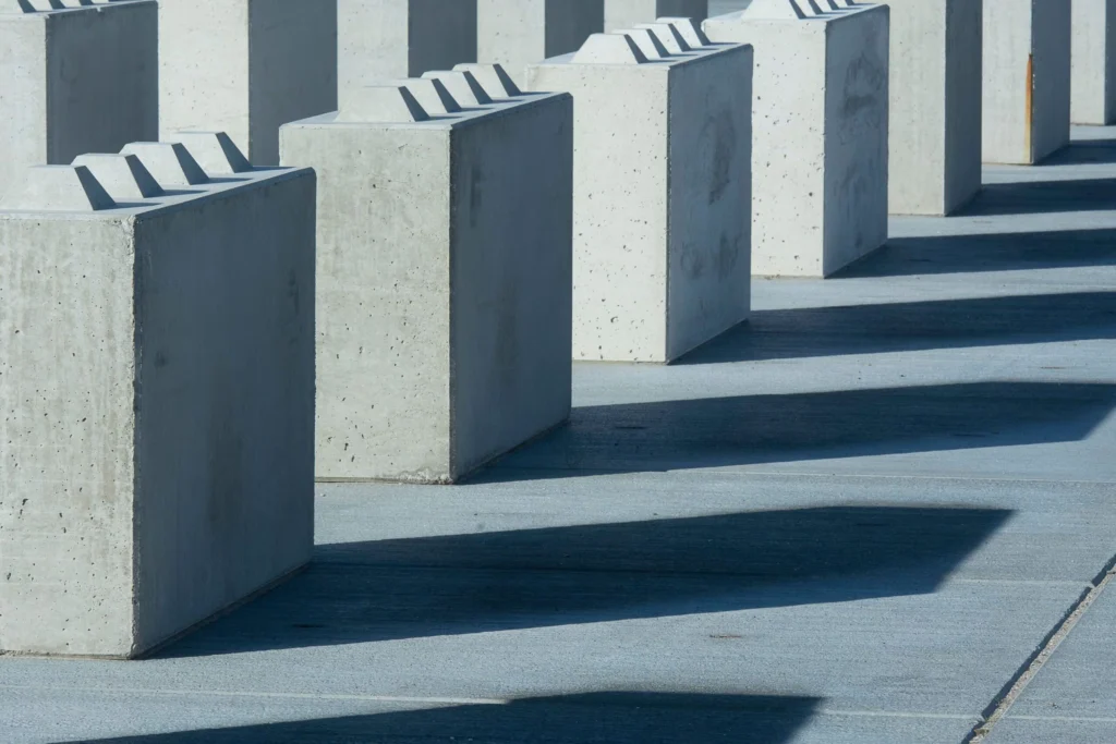 Concrete blocks casting long shadows, creating an urban and abstract pattern.