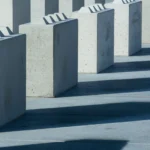 Concrete blocks casting long shadows, creating an urban and abstract pattern.