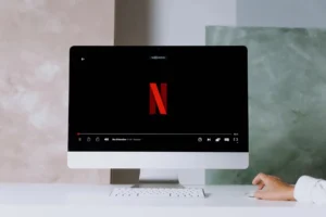 A minimalist workspace scene featuring a desktop displaying a streaming service, ideal for modern lifestyle themes.