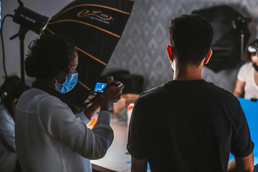 Capture of a photoshoot with people and equipment in a professional studio.