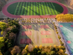 Aerial photograph of a football and tennis court in Nanjing, China during autumn.