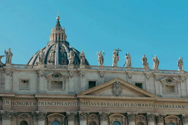 Stunning view of St. Peter's Basilica in Vatican City, highlighting its classic architecture and intricate statues.
