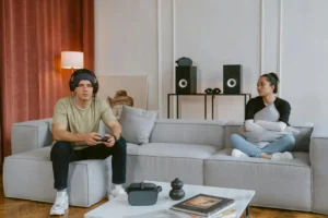 A couple enjoys gaming and relaxation in a stylish living room setting.