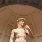 Low angle view of Michelangelo's David sculpture in Florence museum dome.