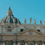 Stunning view of St. Peter's Basilica in Vatican City, highlighting its classic architecture and intricate statues.