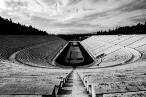 Striking black and white photo of the historic Panathenaic Stadium in Athens, Greece, showcasing its grandeur.