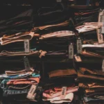 Neatly folded clothes with price tags on shelves in a Taipei shop.