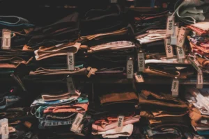 Neatly folded clothes with price tags on shelves in a Taipei shop.