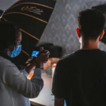 Capture of a photoshoot with people and equipment in a professional studio.
