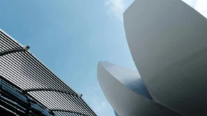 Dynamic view of sleek architectural designs reaching into a clear blue sky.