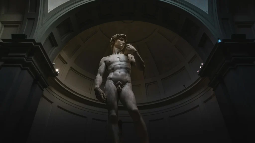 Low-angle shot of Michelangelo's David in Florence's Accademia Gallery.