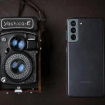 A vintage Yashica camera next to a modern smartphone, showcasing old and new technology.