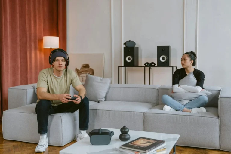 A couple enjoys gaming and relaxation in a stylish living room setting.