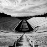 Striking black and white photo of the historic Panathenaic Stadium in Athens, Greece, showcasing its grandeur.