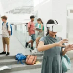 Group of students exploring virtual reality technology at a modern school setting.