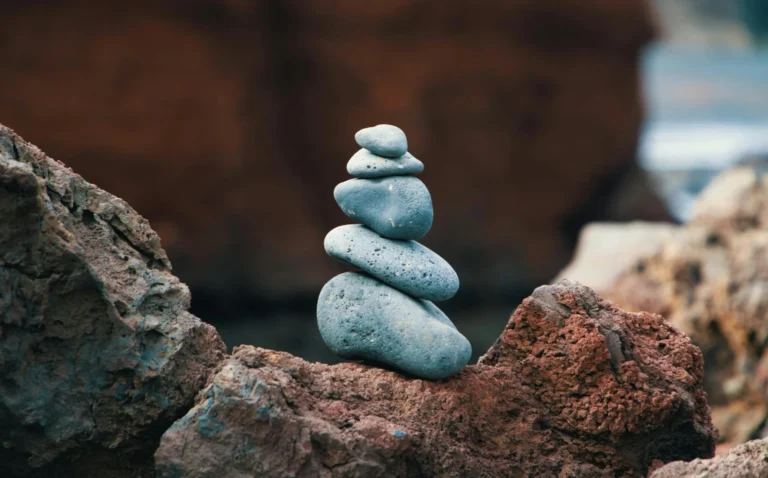 Peaceful arrangement of balanced stones in an outdoor rocky setting, symbolizing harmony.