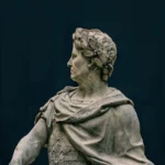 Close-up of a marble statue depicting a classical historical figure with intricate details.