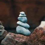 Peaceful arrangement of balanced stones in an outdoor rocky setting, symbolizing harmony.